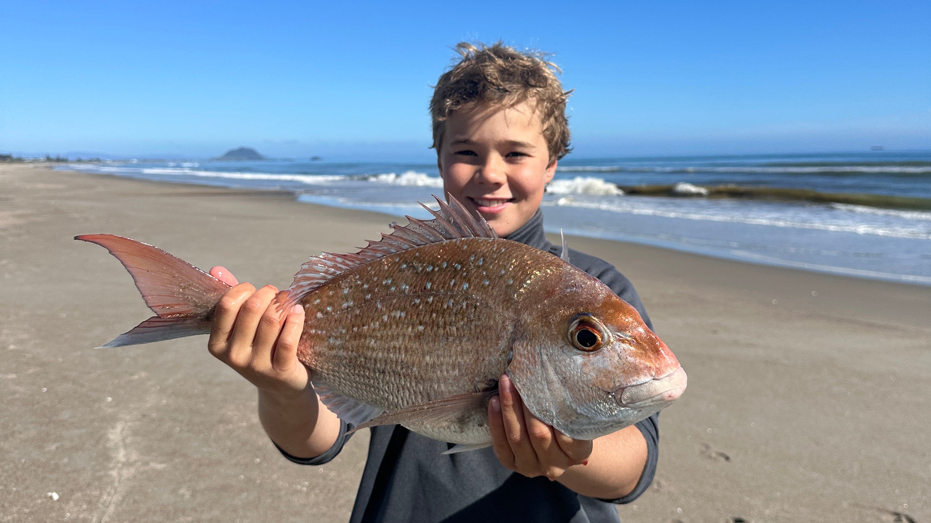 Kids fishing on Papamoa Beach